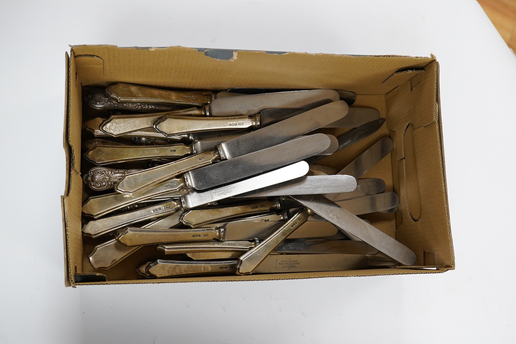A set of twelve George V silver handled table knives and twelve matching dessert knives, Mappin & Webb, Sheffield, 1926, eight other silver handled dessert knives and a silver handled carving knife. Condition - poor to f